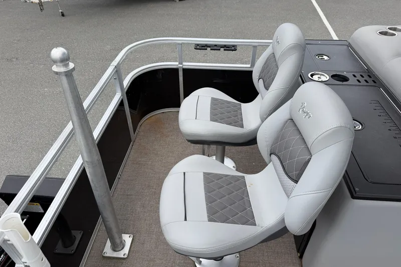 Slide: The Image of 2021 Ranger Reata 223FC boat seats with gray upholstery and fishing rod holder. - 11