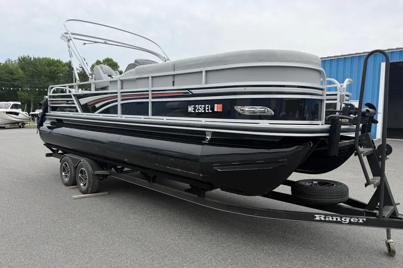 Slide: The Image of 2021 Ranger Reata 223FC pontoon boat on trailer, parked outdoors. - 20