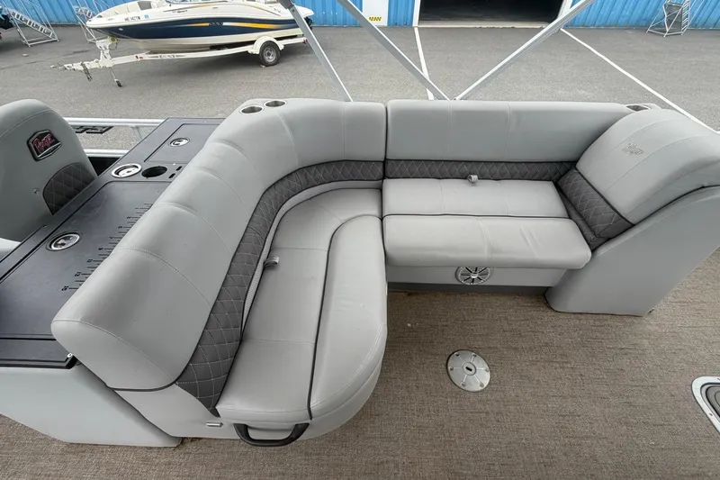 Slide: The Image of 2021 Ranger Reata 223FC boat interior with gray cushioned seating and cup holders. - 13