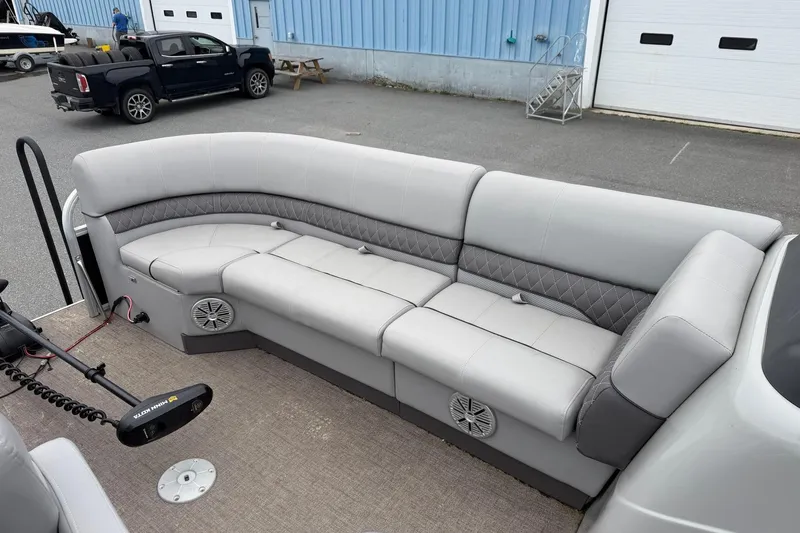Slide: The Image of 2021 Ranger Reata 223FC pontoon boat with spacious gray seating and modern design. - 7