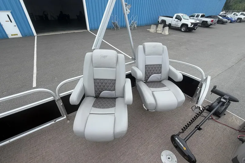 Slide: The Image of 2021 Ranger Reata 223FC boat seats with gray upholstery in a parking lot setting. - 8