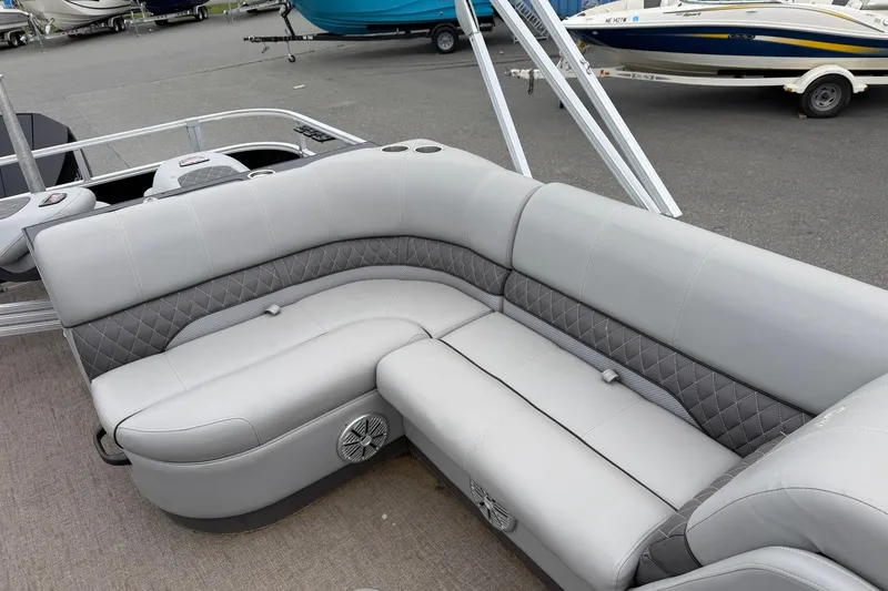 Slide: The Image of 2021 Ranger Reata 223FC boat interior with gray cushioned seating and diamond stitching. - 10