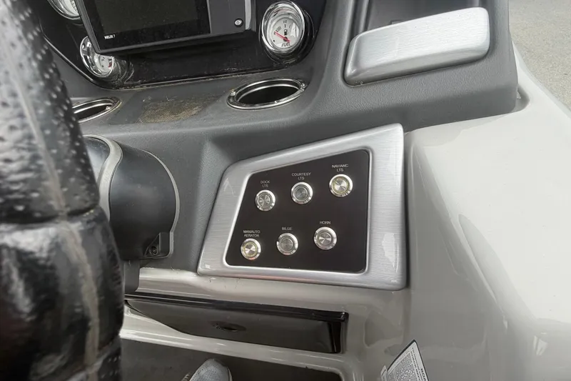 Slide: The Image of Control panel of 2021 Ranger Reata 223FC boat with switches and gauges. - 17