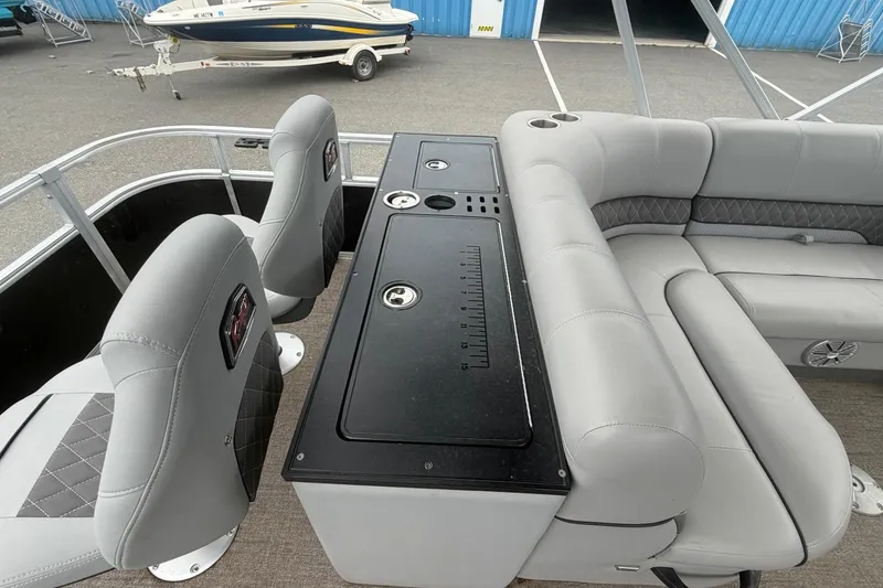 Slide: The Image of 2021 Ranger Reata 223FC boat interior with gray seating and fishing station. - 12