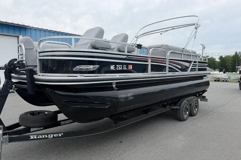 Slide: The Image of 2021 Ranger Reata 223FC pontoon boat on trailer, parked outdoors. - 21