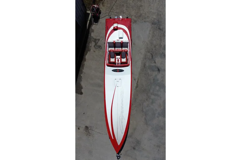 Slide: The Image of 2003 Cigarette 36' Gladiator speedboat, red and white, aerial view on concrete surface. - 4