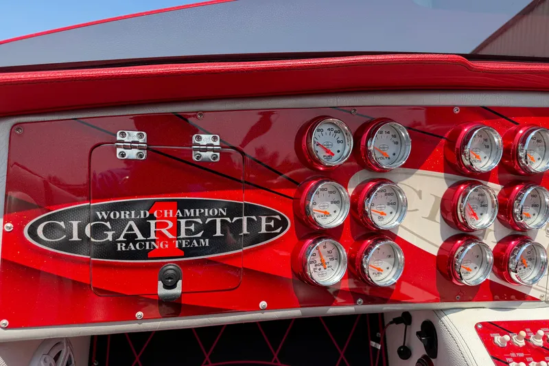 Slide: The Image of Dashboard of 2003 Cigarette 36' Gladiator boat with gauges and racing team logo. - 22