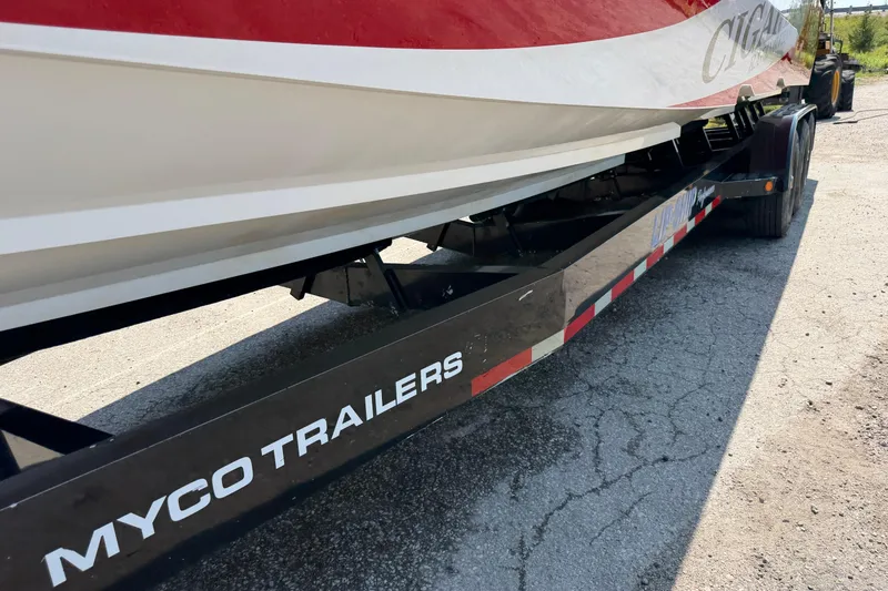 Slide: The Image of 2003 Cigarette 36' Gladiator boat on Myco trailer, parked on asphalt. - 17