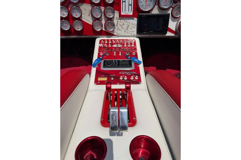 Slide: The Image of Dashboard of a 2003 Cigarette 36' Gladiator boat with red and white controls. - 29