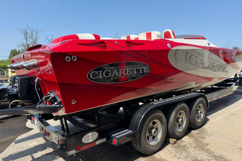 Slide: The Image of 2003 Cigarette 36' Gladiator speedboat in vibrant red on a trailer. - 9