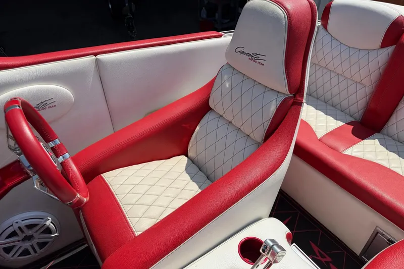 Slide: The Image of Red and white interior of a 2003 Cigarette 36' Gladiator boat, featuring quilted seats. - 27