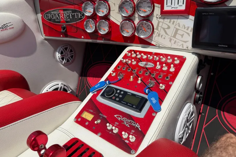 Slide: The Image of Control panel of a 2003 Cigarette 36' Gladiator boat with gauges and switches. - 36