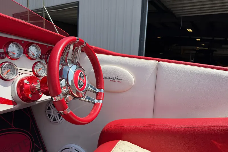 Slide: The Image of 2003 Cigarette 36' Gladiator boat interior with red steering wheel and gauges. - 23