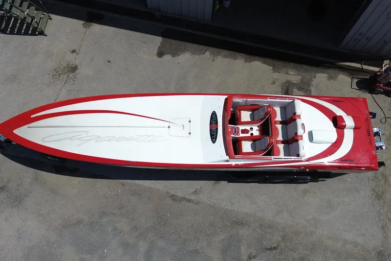 Slide: The Image of 2003 Cigarette 36' Gladiator speedboat, red and white design, aerial view. - 2