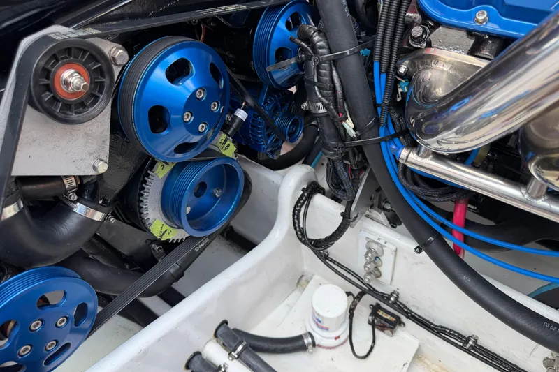 Slide: The Image of Engine components of a 2003 Cigarette 36' Gladiator with blue pulleys and wiring. - 42