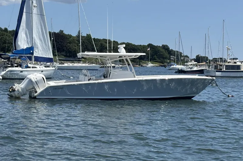 The Image of 2018 Jupiter 34 boat anchored in a scenic harbor with sailboats. - 0