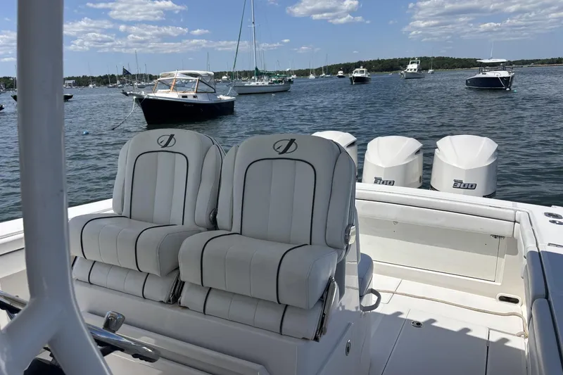 Slide: The Image of 2018 Jupiter 34 boat with twin seats and triple engines on a sunny day. - 3