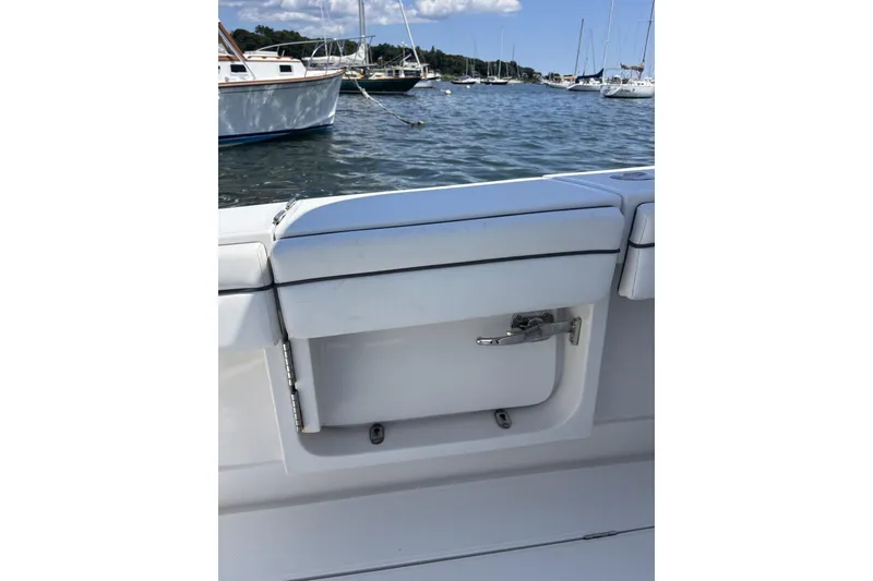 Slide: The Image of 2018 Jupiter 34 boat interior with white seating, docked in a marina. - 11