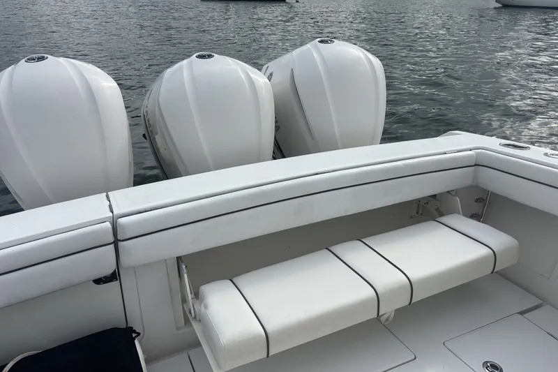 Slide: The Image of 2018 Jupiter 34 boat with triple outboard engines on calm water. - 16