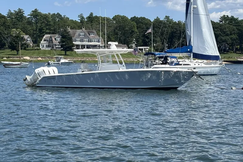Slide: The Image of 2018 Jupiter 34 boat anchored in scenic harbor with sailboats and houses. - 4