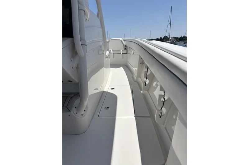 Slide: The Image of 2018 Jupiter 34 boat deck, showcasing sleek design and spacious layout under clear skies. - 10