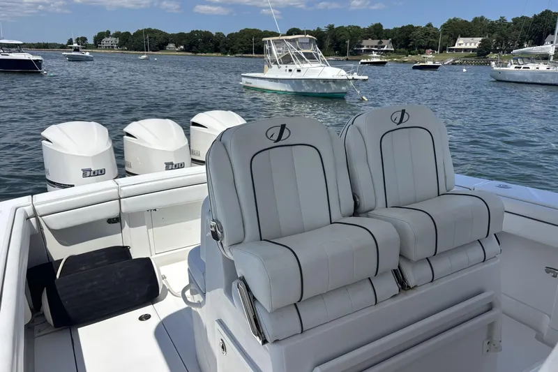 Slide: The Image of 2018 Jupiter 34 boat with Yamaha engines, docked in a scenic marina. - 6