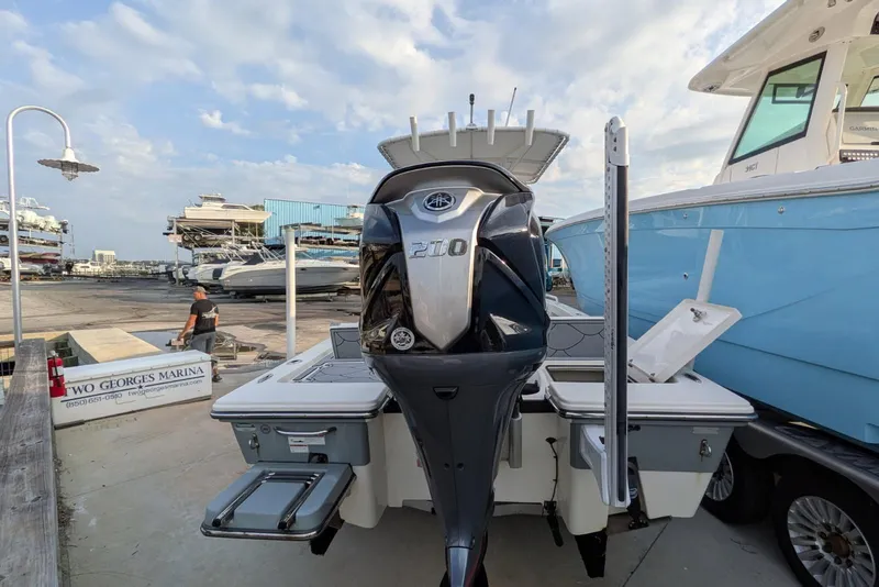 Slide: The Image of 2021 Pathfinder 2200 TRS boat at Two Georges Marina, featuring a powerful outboard motor. - 5