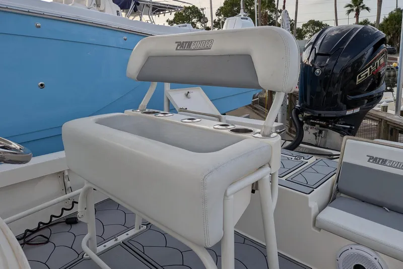 Slide: The Image of 2021 Pathfinder 2200 TRS boat interior with seating and outboard motor. - 13