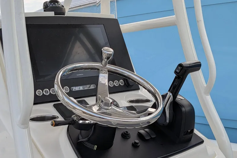 Slide: The Image of Steering console of 2021 Pathfinder 2200 TRS boat with Garmin display and controls. - 12