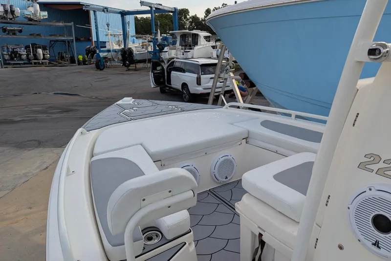 Slide: The Image of 2021 Pathfinder 2200 TRS boat interior at a marina with other boats. - 15