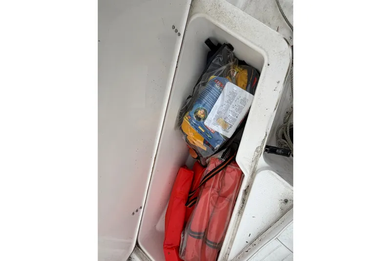 Slide: The Image of Storage compartment on 2006 Seahunt 207 Triton boat with safety gear and equipment. - 12