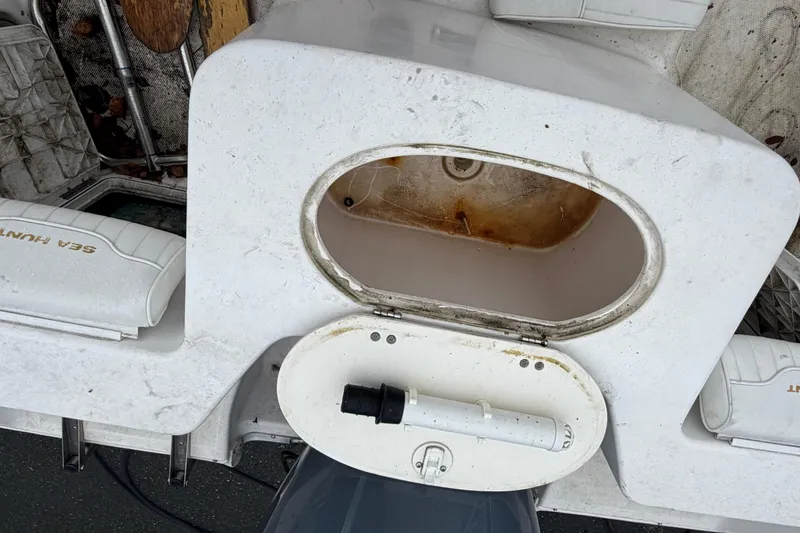 Slide: The Image of A 2006 Sea Hunt Triton 207 with an open storage compartment and two seats. - 6