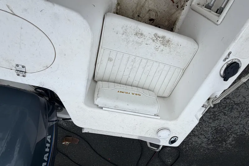 Slide: The Image of 2006 Seahunt 207 Triton boat interior with Yamaha engine, showing seating and deck details. - 7