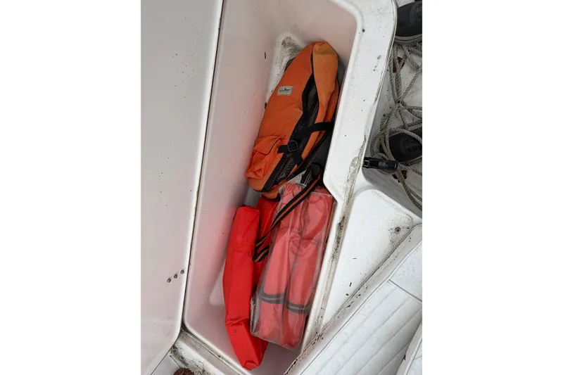Slide: The Image of Storage compartment with life jackets on a 2006 Seahunt 207 Triton boat. - 14