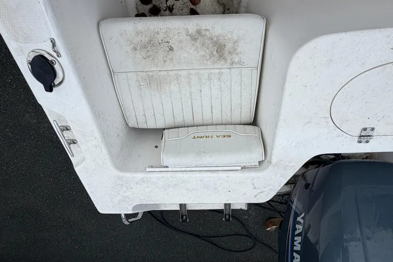 Slide: The Image of 2006 Seahunt 207 Triton boat interior with Yamaha engine, showing seating and storage area. - 8