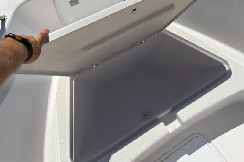 Slide: The Image of Open storage compartment on a 2016 Pro-Line 20 Sport boat. - 19