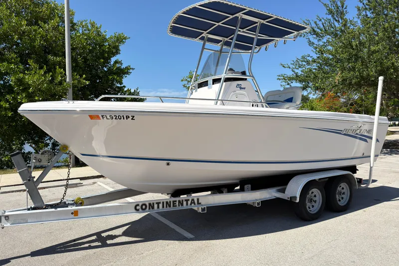 Slide: The Image of 2016 Pro-Line 20 Sport boat on trailer, parked outdoors under clear sky. - 7