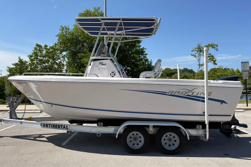 Slide: The Image of 2016 Pro-Line 20 Sport boat on trailer, parked outdoors under clear sky. - 6