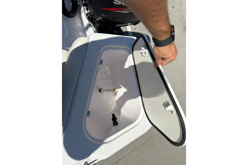 Slide: The Image of Open storage compartment on 2016 Pro-Line 20 Sport boat, showing interior details. - 13