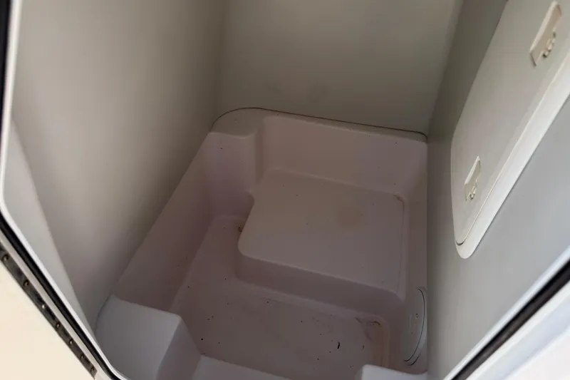 Slide: The Image of Storage compartment inside a 2016 Pro-Line 20 Sport boat, featuring a clean, spacious interior. - 24