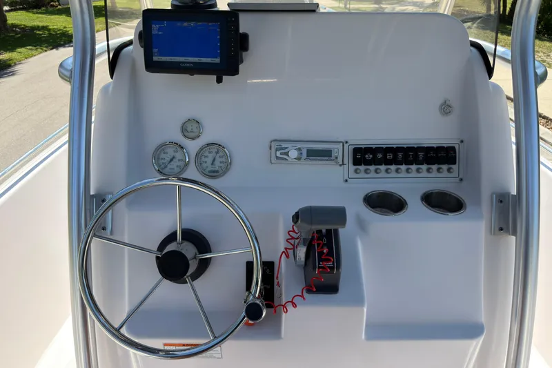 Slide: The Image of Control panel of a 2016 Pro-Line 20 Sport boat with steering wheel and gauges. - 16
