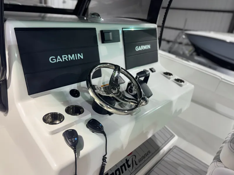 Slide: The Image of The image shows the helm of a 2027 Front Runner Boatworks 37 Cat with Garmin screens. - 30