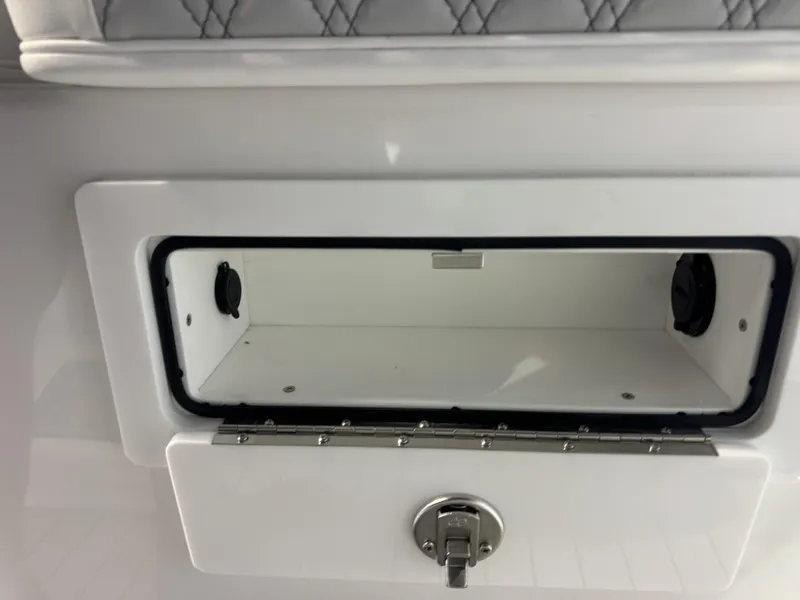 Slide: The Image of An open storage compartment with a latch on a boat. - 8