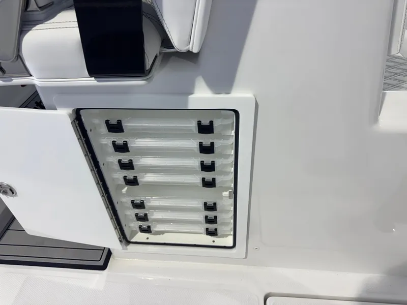 Slide: The Image of A white storage compartment with multiple drawers on a boat. - 9