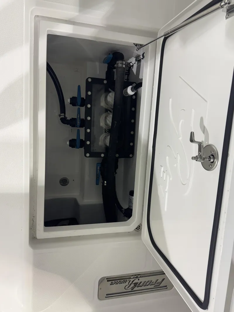Slide: The Image of An open compartment on a boat reveals piping and valves. - 21