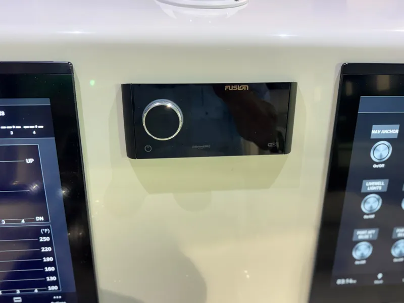 Slide: The Image of The image shows a Fusion audio system between two screens on a boat. - 36