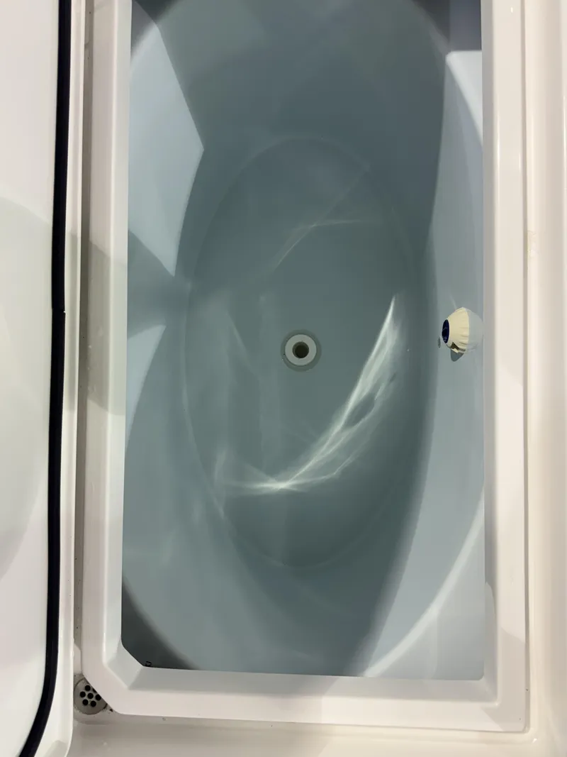 Slide: The Image of A white, oval basin with a central drain, built into a boat. - 18