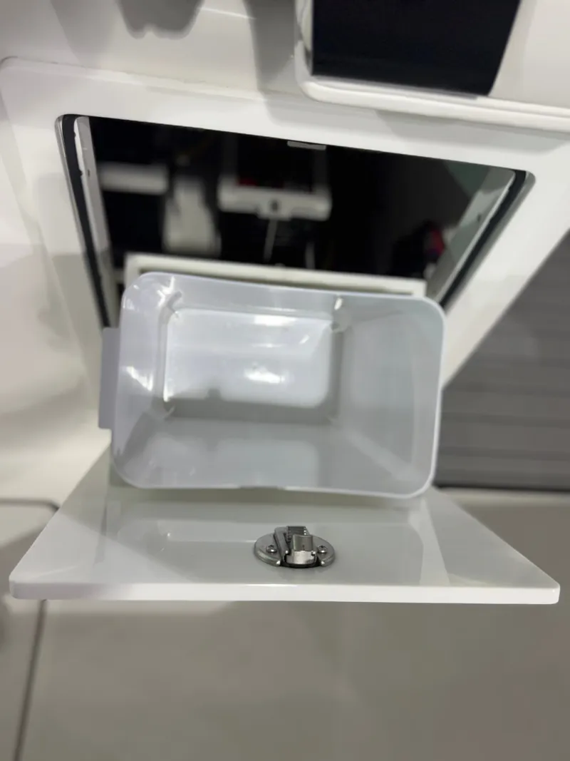 Slide: The Image of A white storage compartment with a removable container and a latch mechanism. - 24