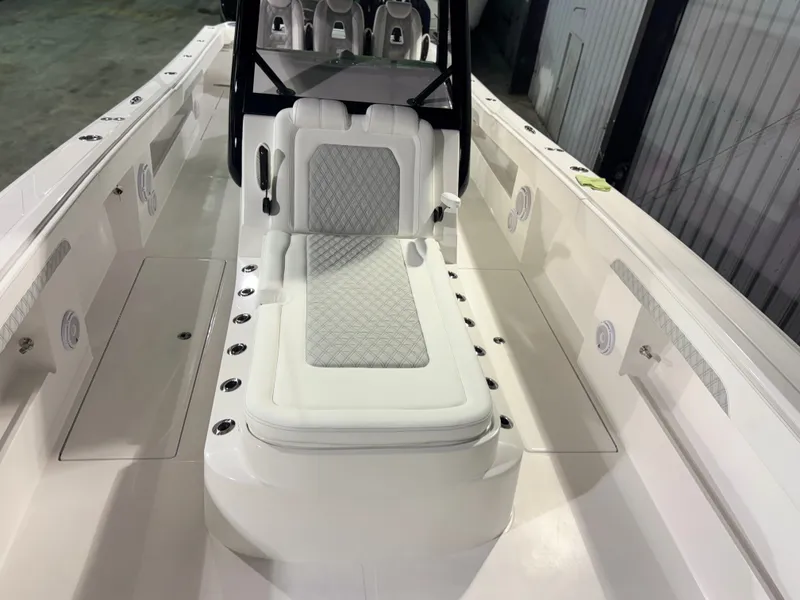 Slide: The Image of The image shows the cockpit of a 2027 Front Runner Boatworks 37 Cat with white upholstery. - 32