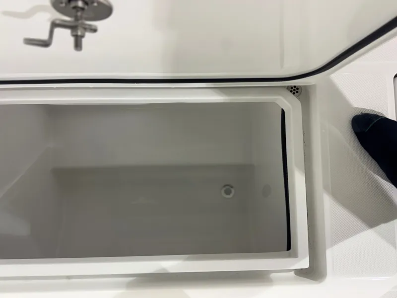 Slide: The Image of An open storage compartment on a boat with a faucet nearby. - 22